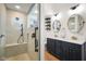Elegant bathroom featuring double sinks, modern fixtures, and a shower with a glass door at 6118 Deerwood Dr, Greenwood, IN 46143
