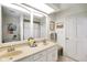 Bright bathroom featuring a double sink vanity and a large mirror at 6118 Deerwood Dr, Greenwood, IN 46143