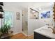 Modern bathroom featuring double sinks, wood floors, a walk-in shower, and shelves at 6118 Deerwood Dr, Greenwood, IN 46143