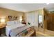 Serene bedroom featuring wood floors, a closet, a bed with neutral linens, and natural lighting at 6118 Deerwood Dr, Greenwood, IN 46143