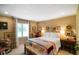Cozy bedroom featuring a bed with a colorful blanket, wood furniture, and natural lighting at 6118 Deerwood Dr, Greenwood, IN 46143