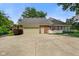 Spacious garage with ample parking and a well-kept yard at 6118 Deerwood Dr, Greenwood, IN 46143