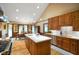 Open kitchen with island, hardwood floors, and stainless steel appliances at 6118 Deerwood Dr, Greenwood, IN 46143