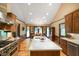 Spacious kitchen with a large island, stainless steel appliances, and a view to the dining area at 6118 Deerwood Dr, Greenwood, IN 46143