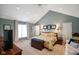 Bright main bedroom featuring vaulted ceilings, a ceiling fan, and blue-gray walls at 6118 Deerwood Dr, Greenwood, IN 46143