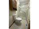 Bathroom with white toilet, shower and wooden cabinet at 613 Monte Vista Dr, Greenwood, IN 46143