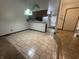 Dining area showcases tiled floor and chandelier, leading to the kitchen and front entrance at 613 Monte Vista Dr, Greenwood, IN 46143