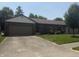 Charming brick home with attached garage, well-kept lawn, and mature shade trees at 613 Monte Vista Dr, Greenwood, IN 46143