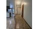 Inviting hallway featuring tiled flooring leading to the kitchen and front door at 613 Monte Vista Dr, Greenwood, IN 46143
