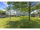 Expansive backyard with lush green grass, mature trees offering shade, and a well-maintained fence at 6563 Enclave Blvd, Greenwood, IN 46143