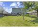 A spacious backyard featuring a large green lawn, mature trees, and a view of the home's exterior at 6563 Enclave Blvd, Greenwood, IN 46143