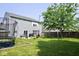 Spacious backyard with a patio, grill, trampoline, and a large tree providing ample shade at 6563 Enclave Blvd, Greenwood, IN 46143