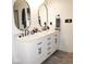 Bathroom boasts double sinks, white cabinets, marble countertop, and modern fixtures at 6563 Enclave Blvd, Greenwood, IN 46143