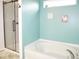 Inviting bathroom featuring a soaking tub, glass shower, and natural light at 6563 Enclave Blvd, Greenwood, IN 46143