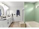 Stylish bathroom with dual sinks, modern fixtures, updated lighting, and a separate soaking tub at 6563 Enclave Blvd, Greenwood, IN 46143