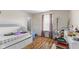 Well-lit bedroom showcasing a trundle bed, hardwood floors, and a tranquil atmosphere for relaxation at 6563 Enclave Blvd, Greenwood, IN 46143
