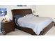 Bedroom with dark wood furnishings, including two nightstands, a stylish bed frame, and soft carpeting at 6563 Enclave Blvd, Greenwood, IN 46143