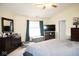 Comfortable bedroom featuring dark wood dresser and furnishings, TV and plush carpeting with an area rug at 6563 Enclave Blvd, Greenwood, IN 46143