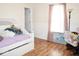 Bright bedroom with hardwood floors, natural light, and a cozy atmosphere at 6563 Enclave Blvd, Greenwood, IN 46143