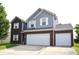 Beautiful home showcasing a brick and vinyl exterior, a two-car garage, and a neat front yard at 6563 Enclave Blvd, Greenwood, IN 46143