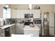 Modern kitchen featuring white cabinets, an island, stainless steel appliances, and a tiled backsplash at 6563 Enclave Blvd, Greenwood, IN 46143