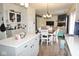 Bright kitchen with white countertop island flows into a dining area and living room with a fireplace at 6563 Enclave Blvd, Greenwood, IN 46143