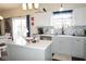 Well-lit kitchen with white cabinets, gray countertops, stainless steel appliances and a gray subway tile backsplash at 6563 Enclave Blvd, Greenwood, IN 46143