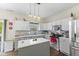 Modern kitchen with stainless steel appliances, center island and pendant lighting at 6563 Enclave Blvd, Greenwood, IN 46143
