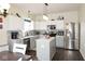 Spacious kitchen with white cabinets, an island, stainless steel appliances, and sleek countertops and backsplash at 6563 Enclave Blvd, Greenwood, IN 46143