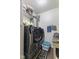 Bright laundry room featuring a modern washer and dryer, shelving, and ample storage space at 6563 Enclave Blvd, Greenwood, IN 46143