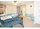 Spacious living room with blue sectional couch, an adjacent bathroom, and natural light at 6563 Enclave Blvd, Greenwood, IN 46143