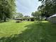 Expansive backyard with lush lawn and mature trees at 7150 Combs Rd, Indianapolis, IN 46237