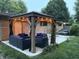Cozy backyard patio with a charming pergola, outdoor seating, and manicured landscaping for relaxing and entertaining at 7150 Combs Rd, Indianapolis, IN 46237