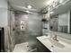 Modern bathroom with gray stone tile shower, modern sink and decorative mirror at 7150 Combs Rd, Indianapolis, IN 46237