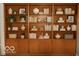 Well-lit bookcase with books and decorative pieces at 7150 Combs Rd, Indianapolis, IN 46237