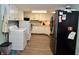Spacious kitchen with white cabinetry, stainless steel appliances and washer/dryer at 7150 Combs Rd, Indianapolis, IN 46237