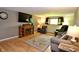 Cozy living room with hardwood floors, a fireplace, and comfortable seating area at 7150 Combs Rd, Indianapolis, IN 46237