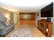 Spacious living area with hardwood floors, built-in shelving, and a decorative fireplace at 7150 Combs Rd, Indianapolis, IN 46237