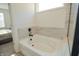 Clean bathroom features a soaking tub with tile surround and a window for natural light at 7284 Bayview Run, McCordsville, IN 46055