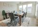 Formal dining room with a modern chandelier, a large window, and seating for six people at 7284 Bayview Run, McCordsville, IN 46055
