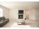 Spacious living room with comfortable seating, fireplace, mounted TV, and neutral carpeting, perfect for relaxation and entertainment at 7284 Bayview Run, McCordsville, IN 46055
