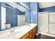 Bathroom features a double sink vanity, glass-enclosed shower, tile floors, and a large mirror at 7337 Wythe Dr, Noblesville, IN 46062
