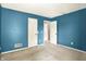 This bedroom features carpet and blue walls, as well as multiple doorways at 7337 Wythe Dr, Noblesville, IN 46062