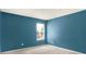This bedroom has blue walls, carpet, and a window to provide light at 7337 Wythe Dr, Noblesville, IN 46062