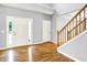 Spacious foyer with wood floors, staircase, and a view of the front door at 7337 Wythe Dr, Noblesville, IN 46062