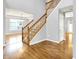 Open foyer with wood floors, staircase, and views into other rooms at 7337 Wythe Dr, Noblesville, IN 46062