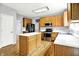 Efficient kitchen featuring wood cabinets, stainless steel appliances, an island, and sleek countertops at 7337 Wythe Dr, Noblesville, IN 46062