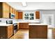 Modern kitchen with stainless steel appliances, a kitchen island, light counter tops and wood cabinets at 7337 Wythe Dr, Noblesville, IN 46062