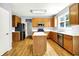 Functional kitchen with wood cabinets, stainless steel appliances, an island, and sleek countertops at 7337 Wythe Dr, Noblesville, IN 46062