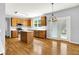 Bright kitchen with stainless-steel appliances, an island, wood cabinets, and access to the backyard through French doors at 7337 Wythe Dr, Noblesville, IN 46062